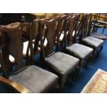 A set of four walnut Queen Anne style single chairs