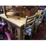 A modern oak extending dining table and four chairs