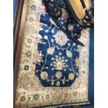 A Persian design blue ground rug