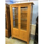 A light oak Chapmans Siesta glazed cabinet