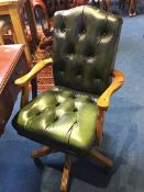 A green leather Chesterfield office chair