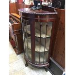 A mahogany half moon china cabinet