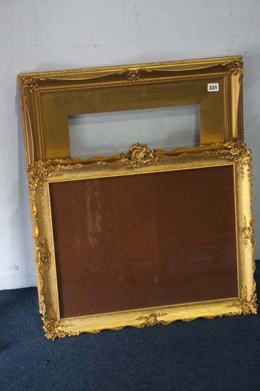 A pair of ornate gilt frames and one other