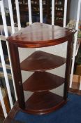 A mahogany hanging corner cabinet