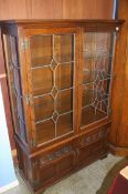 An oak leaded glass two door bookcase