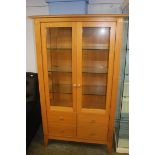 A light oak two door display cabinet