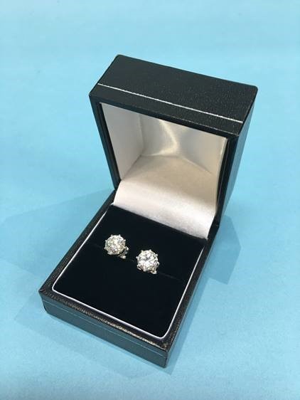 A pair of diamond earrings, each diamond approximately 1 carat