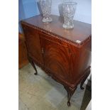 A reproduction mahogany cocktail cabinet