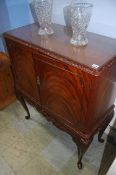 A reproduction mahogany cocktail cabinet