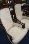 A pair of cream upholstered arm chairs
