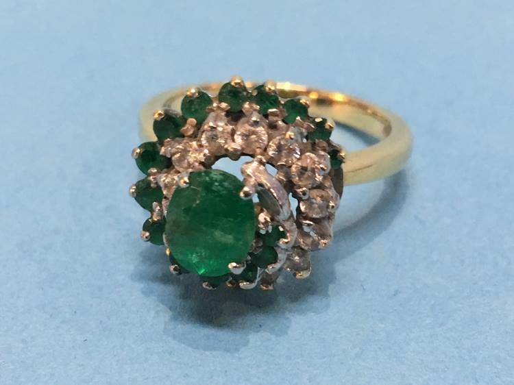 An 18ct ring, mounted with diamonds and emeralds