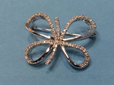 A diamond encrusted white metal (stamped 750) brooch, 10 grams