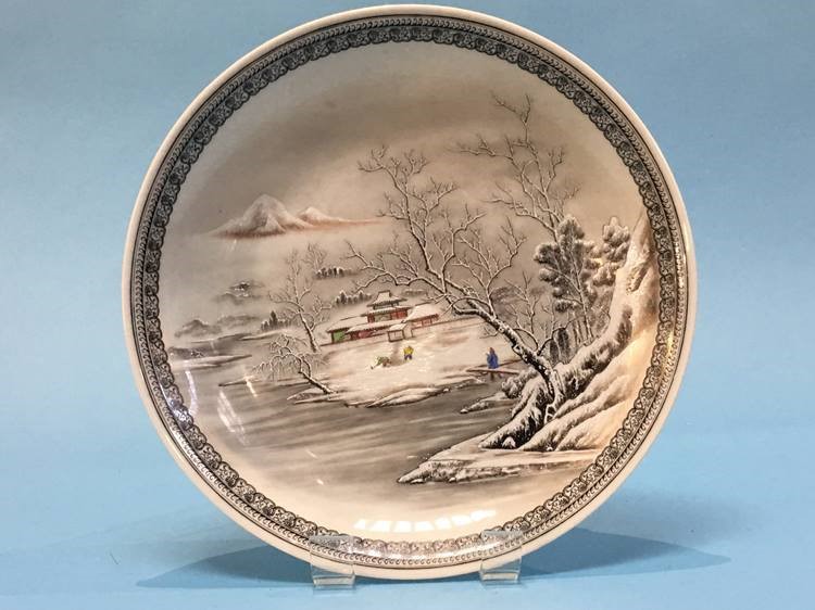 An Oriental circular dish, the centre decorated with a Winter landscape. 33.5 cm diameter