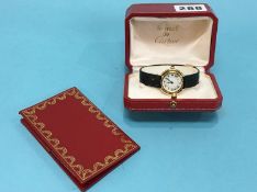 A Ladies 18ct gold wristwatch, the dial signed Cartier with box and some paperwork