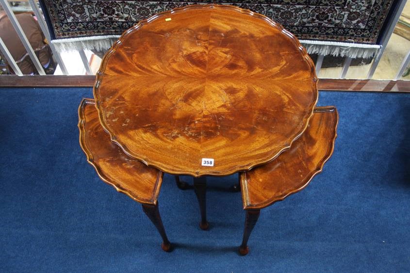 A mahogany circular nest of tables