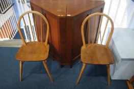 Two teak corner cabinets and a pair of stick back chairs