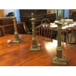 A set of three Corinthian column brass table lamps