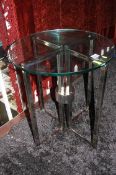 A modern glass top and chrome occasional table