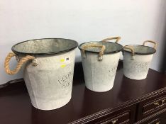 Three graduated decorative buckets