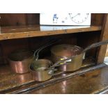 Set of six graduated copper pans