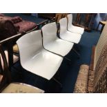 Set of four white and chrome swivel chairs