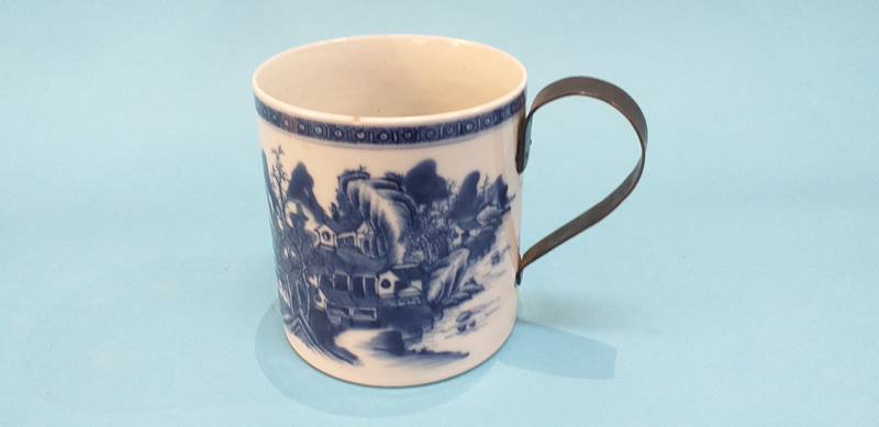 An Oriental blue and white tankard, with replacement metal looped handle