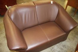 A small brown two seater settee