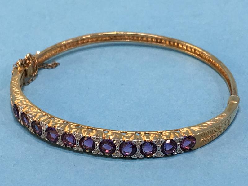 A 9ct gold amethyst and diamond bangle