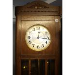 A 1930's oak long case clock