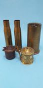 Three brass shells, a small cast iron inkwell and a brass tankard shaped string box (3)