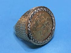 A gentleman's 9ct ring, mounted with a full sovereign, dated 1887, total weight 16.2g