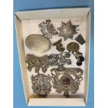 A collection of various white metal crests, cap badges etc.