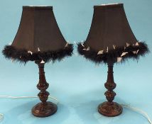 A pair of carved wood table lamps