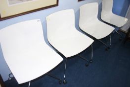 A set of four Arper swivel chairs