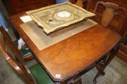 A walnut dining table and four chairs