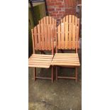 Four teak folding chairs