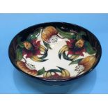 A modern circular Moorcroft shallow bowl, decorated with lilies, 25cm diameter
