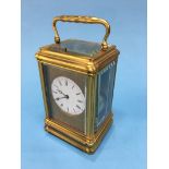 A good quality carriage clock, with strike action, enamelled circular dial and engraved