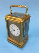 A good quality carriage clock, with strike action, enamelled circular dial and engraved