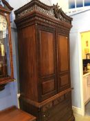 A reproduction mahogany Oriental style wardrobe with panelled doors, below three short and three