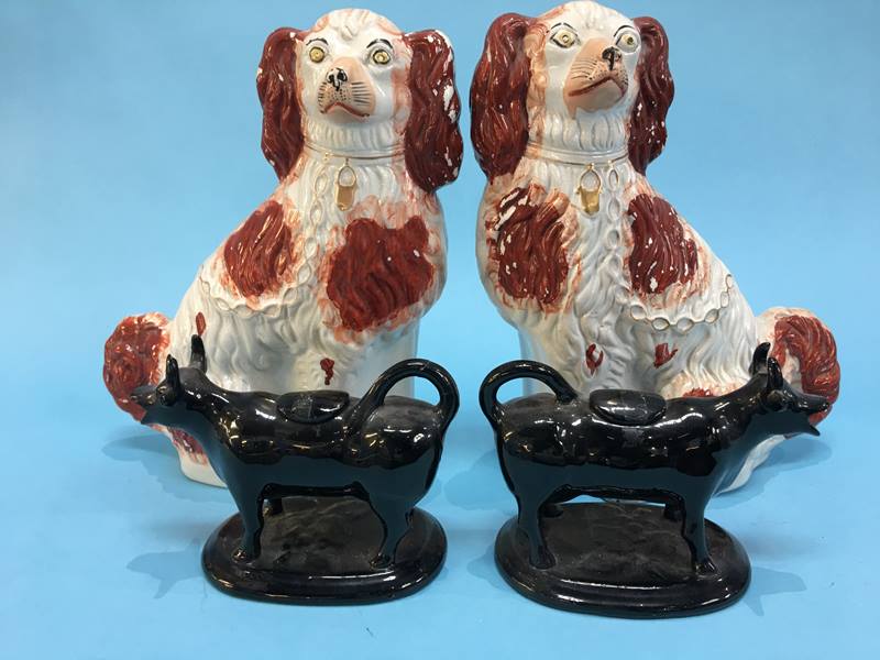 A pair of Staffordshire Spaniels and a pair of cow creamers