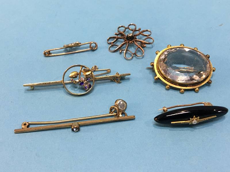 A collection of various brooches, some 9ct, one stamped 15 etc.