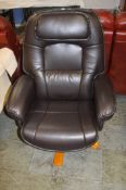 A black leather swivel and reclining armchair