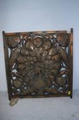 A copper Art and Crafts style pierced panel, decorated with a peacock and stylised flowers. 61cm x