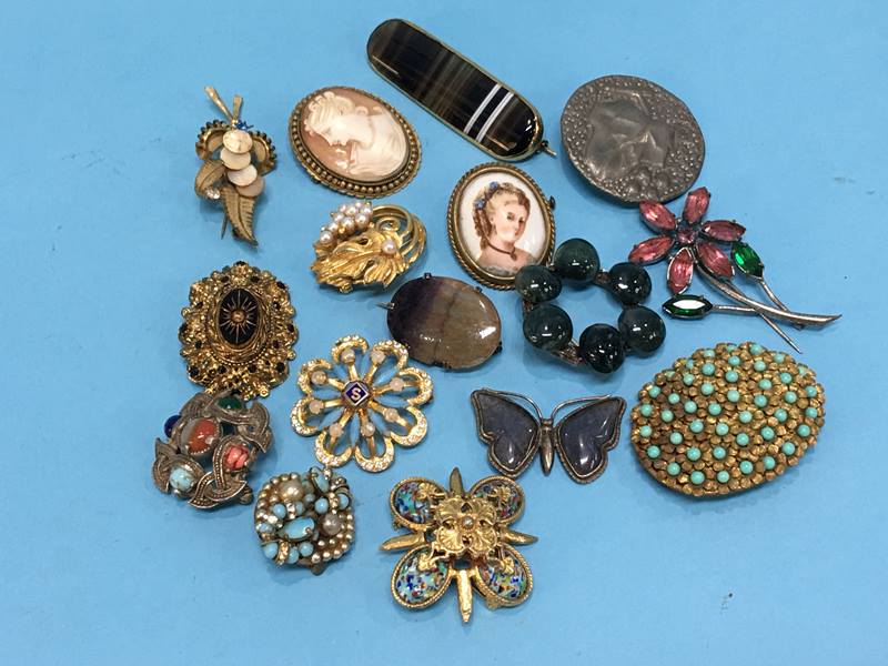 A bag of assorted brooches