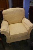 A cream floral patterned armchair