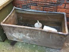 A galvanised trough, chicken feeder etc.