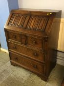 An oak linenfold bureau