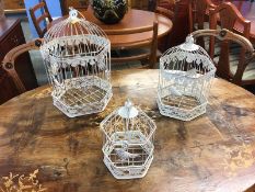 Three graduated bird cages