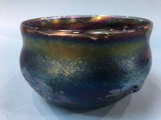 A John Ditchfield shallow circular bowl of metallic purples, numbered 5586, 17cm diameter